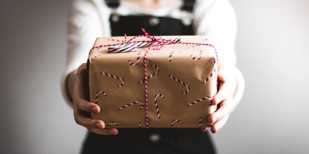 free delivery convenience person showing brown gift box